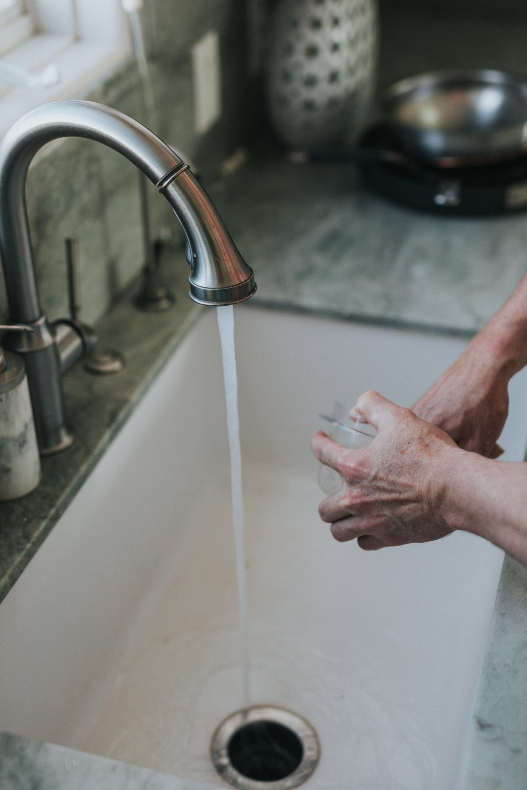 a hand holding a water bottle