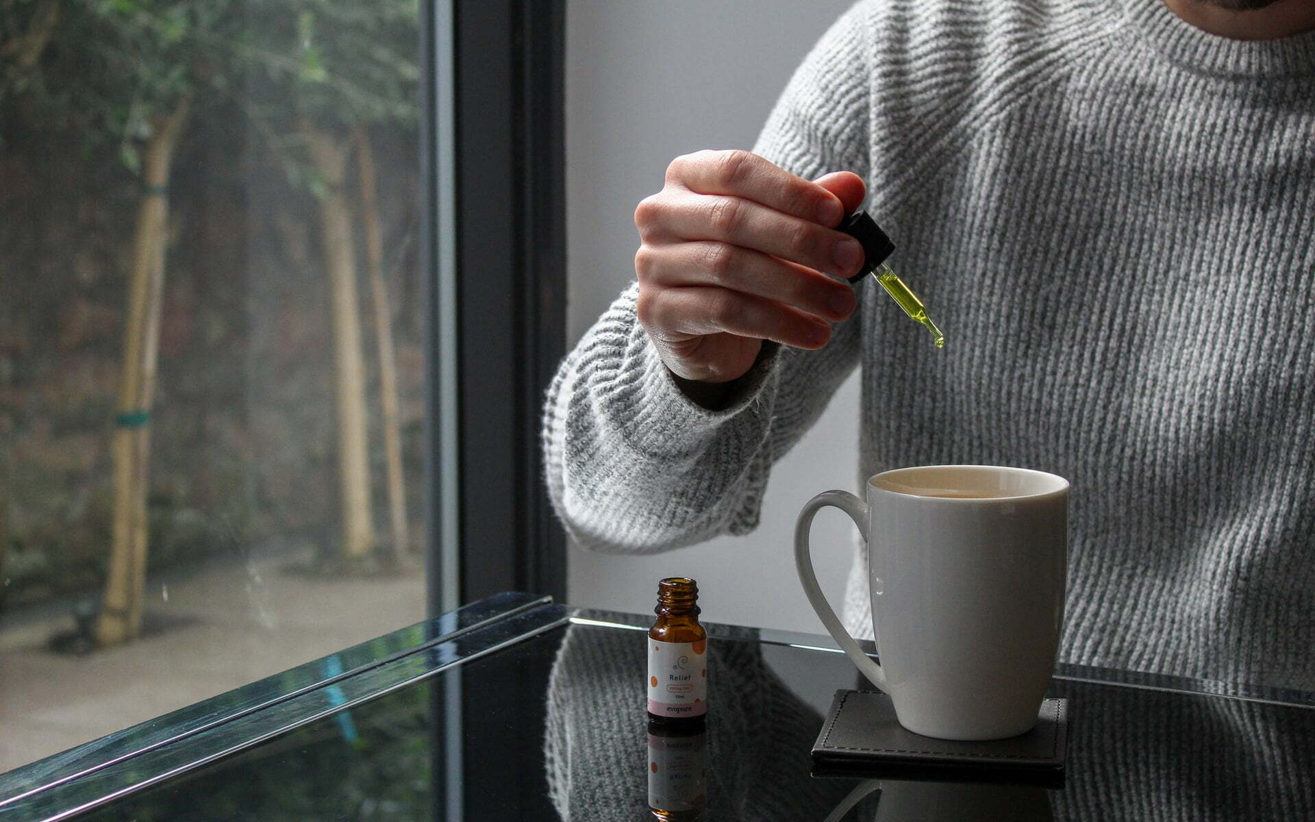 a person pouring a liquid into a cup